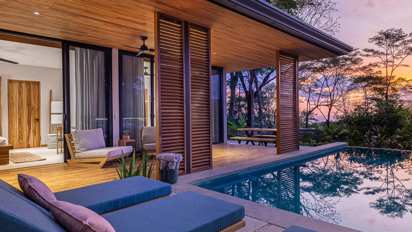 Villa terrace and infinity pool overlooking the valley at sunset
