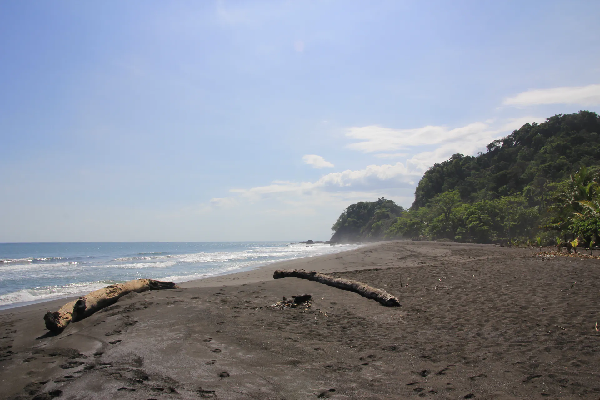 Black sand, forested headland and Pacific water at Playa Hermosa, Garabito, Costa Rica.