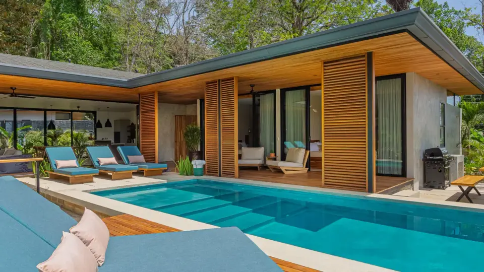 Modern wood-slat villa with a pool and sun loungers